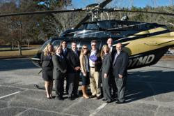 The Grand Estates Auction Company team with the winning bidder of the Lake Lanier absolute auction.